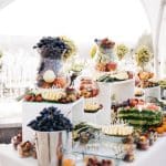 glass vase with grape stand dinner table with fruits